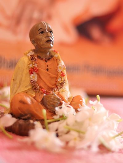 pexels-photo-6000928-6000928 Close-up of a religious figurine adorned with flowers, emphasizing spiritual devotion.
